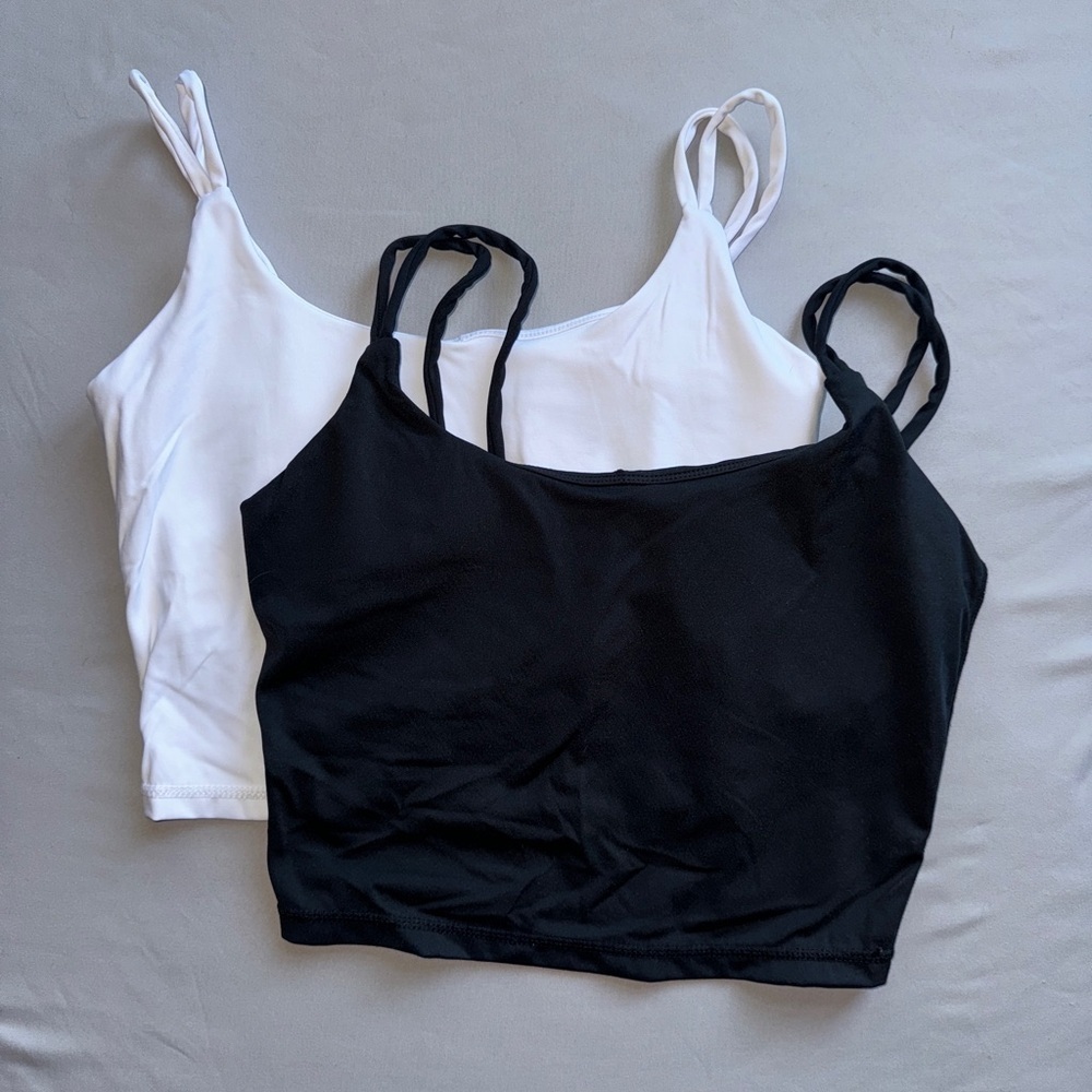 Two MusesOnly Sports Bra, one white and one black